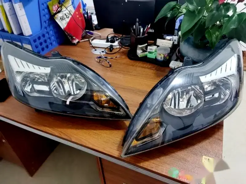 Removed headlight assembly from a 2010 Ford Focus, prepared for a DIY retrofit with projector headlights / bi projector headlights.