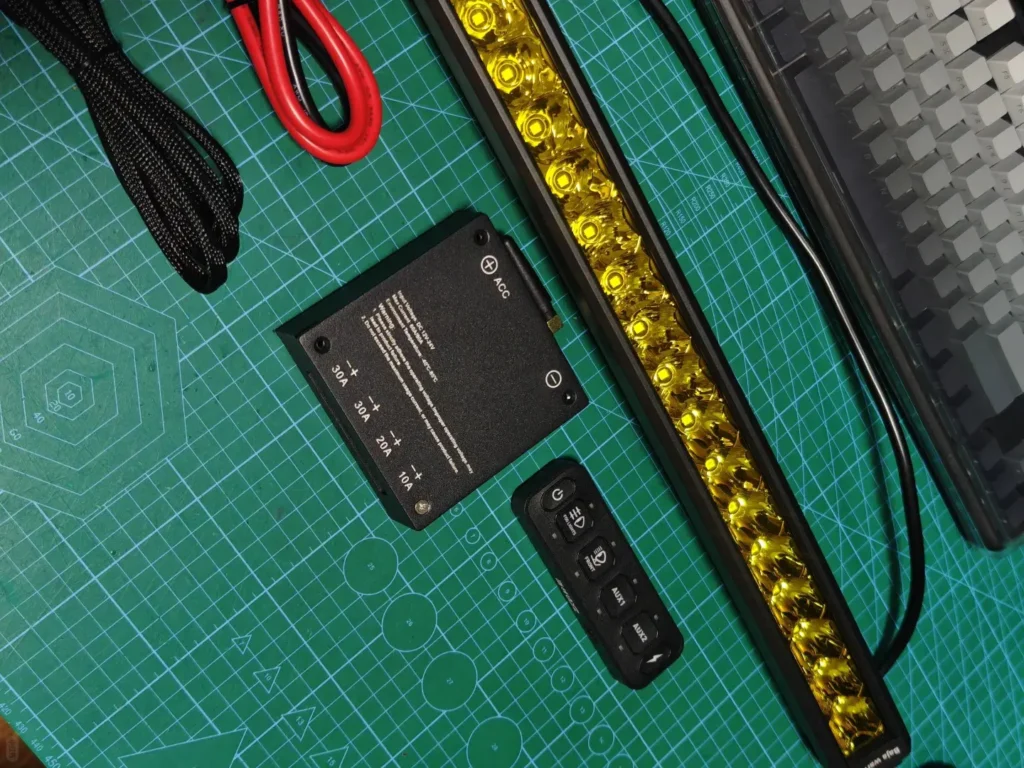 ACC (accessory power) trigger and LED grill lights laid out on a desk before installation, illustrating a simple automatic-on control approach.