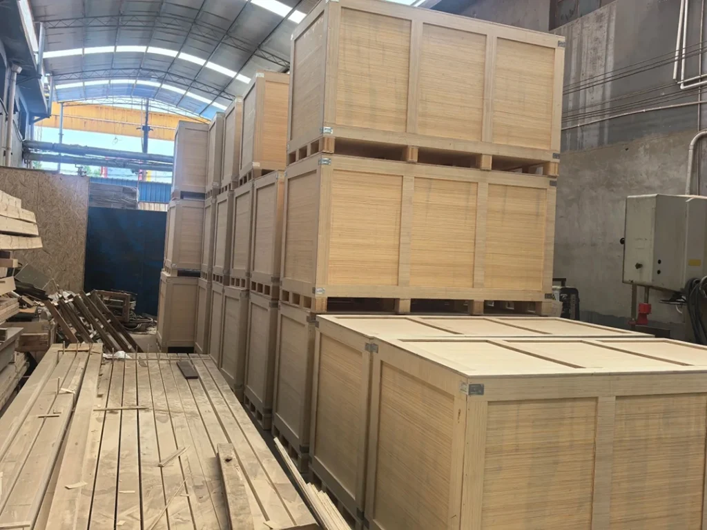 Multiple aftermarket projector headlights packed on pallets in a warehouse, ready for shipment