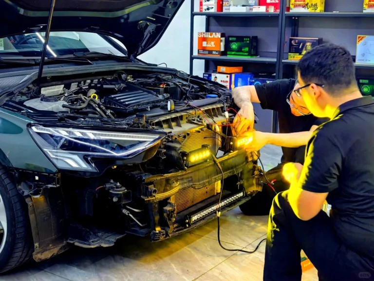 Technician inspecting the wiring of an Audi A3 during car grill lights troubleshooting to identify and fix a fault
