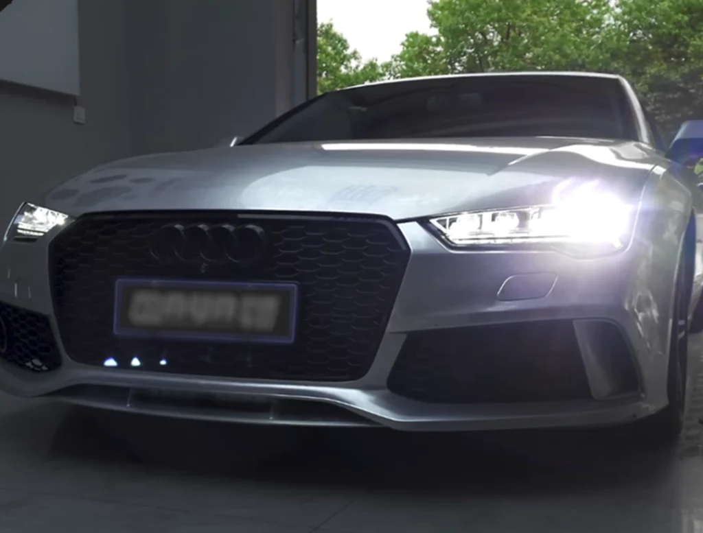 Audi at night with projector headlights, cover image for a headlight upgrade article