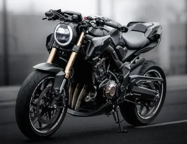 Black-and-white portrait of a black motorcycle after a headlight upgrade with projector headlights for bikes