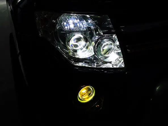 Car headlights and fog lights on at night showing fog lamp for car illumination
