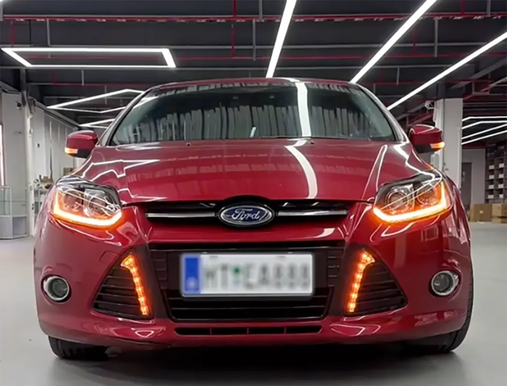 Red Ford EcoSport on the road with ecosport projector headlight upgrade installed