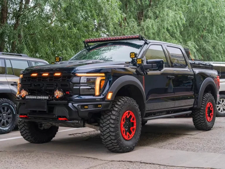 Front view of a modified Ford F-150 Raptor featuring amber grille LED lights, illustrating a commonly compliance-friendly exterior lighting choice (rules vary by region).