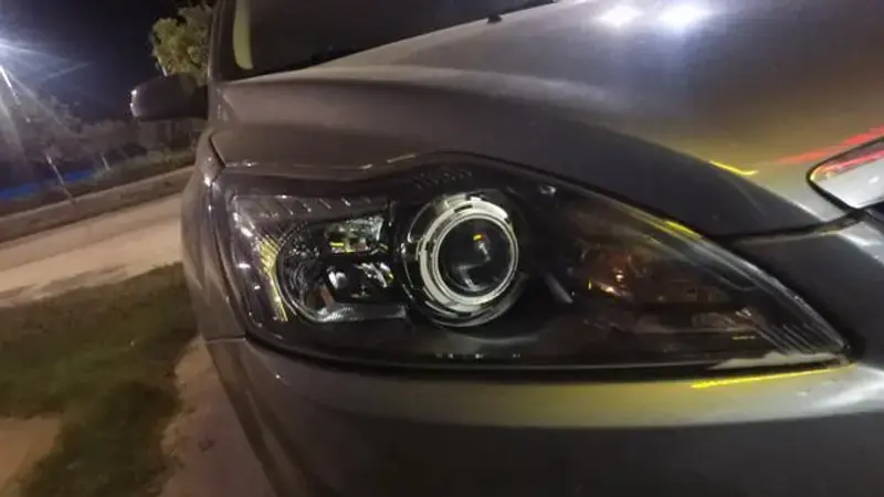 Close-up of a Ford Focus front end with the headlight assembly prepared for installation.
