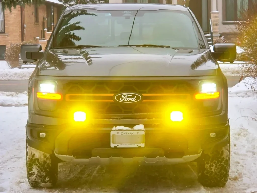 Ford SUV with fog lamps turned on, showing low and wide illumination for foggy conditions