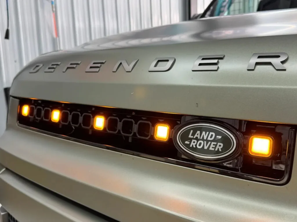 and Rover Defender with amber grille lights installed in the front grille.