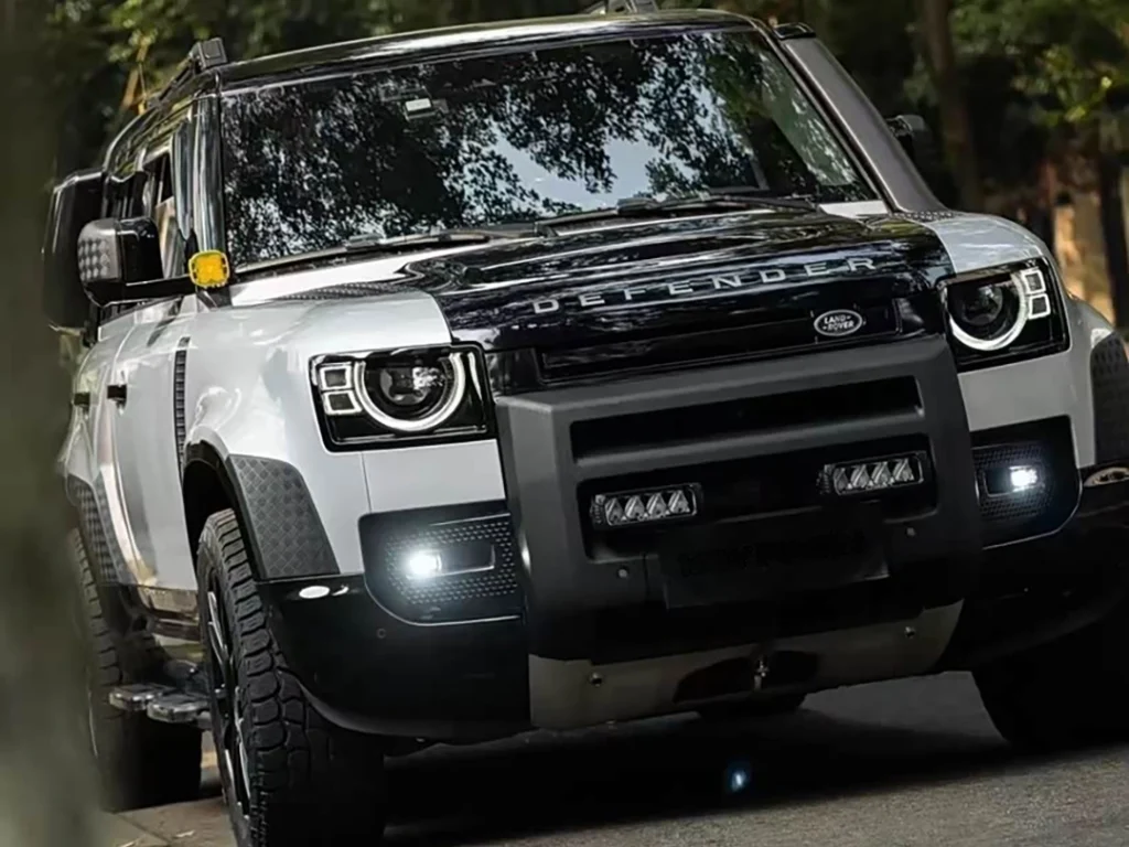 Land Rover driving on the road with led grill lights installed in the front grille (police grill lights style).