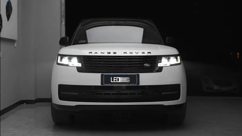 Land Rover with our LED projector headlights turned on, showing focused beam pattern and bright road illumination