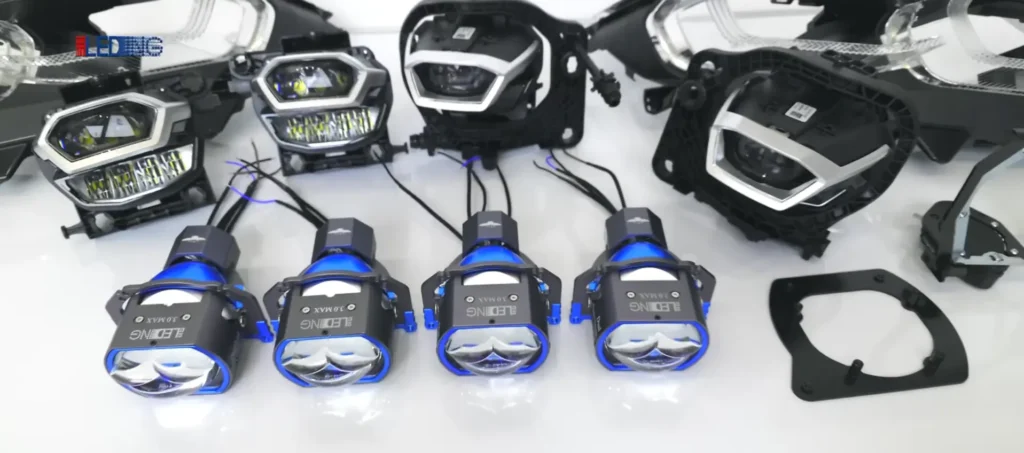 Removed headlight housing with new OEM projector lens units unpacked and ready for installation in a projector headlights factory