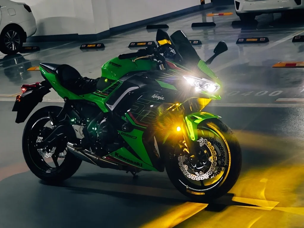 Motorcycle with projector headlights for bikes, showing a controlled beam pattern that reduces glare and improves visibility on wet roads