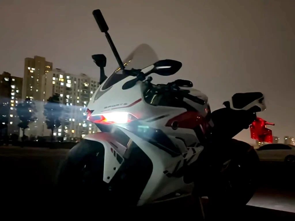 Motorcycle equipped with projector headlights for bikes, showing focused beam pattern and improved visibility during evening riding