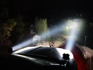 SUV with Leding LED spotlights projecting a long-range beam ahead.