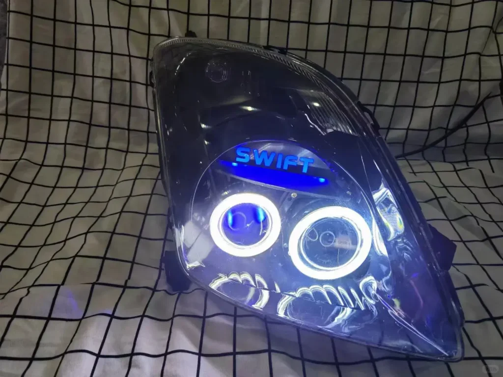 Swift headlight removed from the car with swift projector headlight retrofit, powered on for bench testing