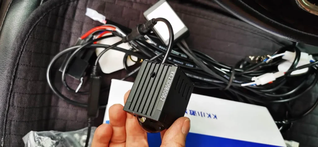 Technician connecting wiring inside the vehicle to install LED grill lights.