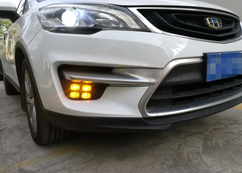 White car with fog lights on during daytime checking fog lamp for car operation