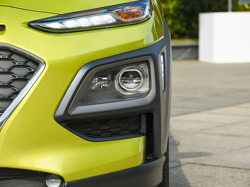 Close-up of a yellow sedan using our fog light in daylight, highlighting the lens, housing, and fitment—best fog light for car