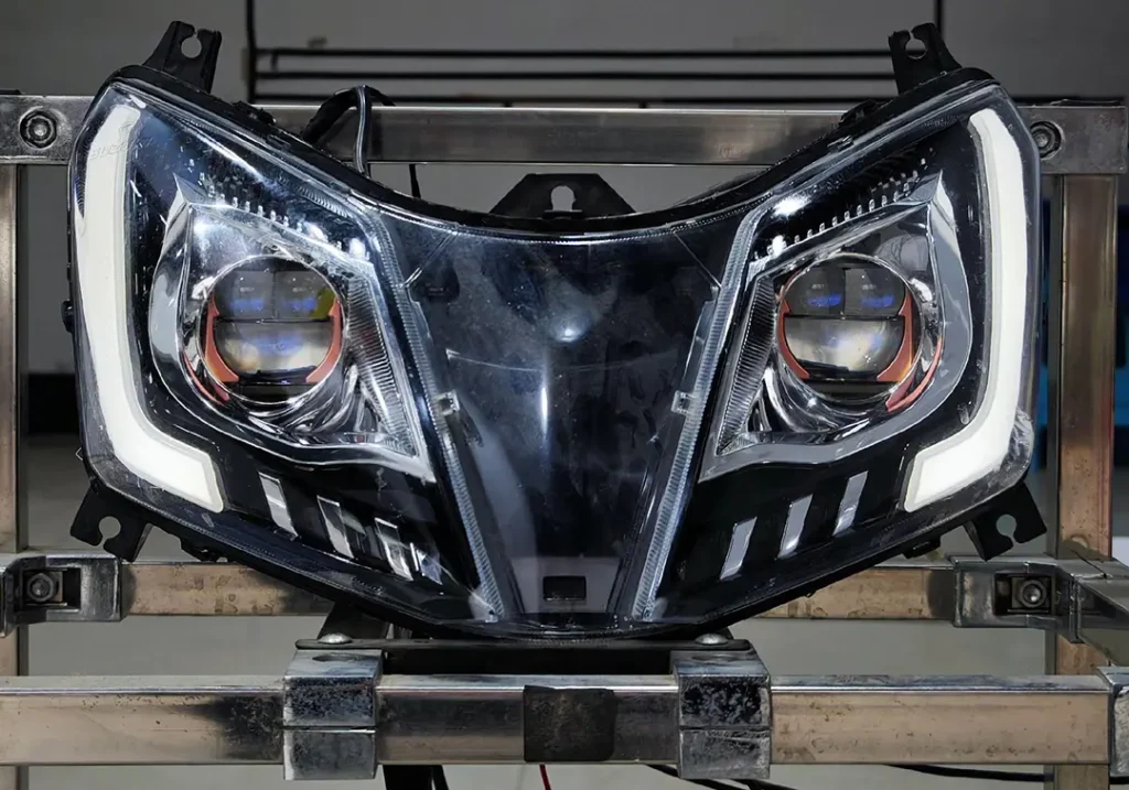 Motorcycle headlight housing on a stand with bike projector lights installed