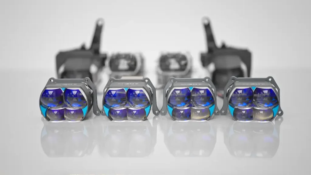 OEM projector headlights: four projector lens lamps arranged on a tabletop with the logo clearly visible on top.