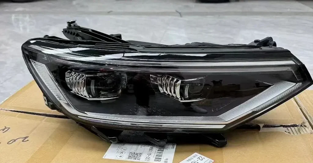 Volkswagen Magotan headlight assembly removed and prepared for a projector retrofit installation.