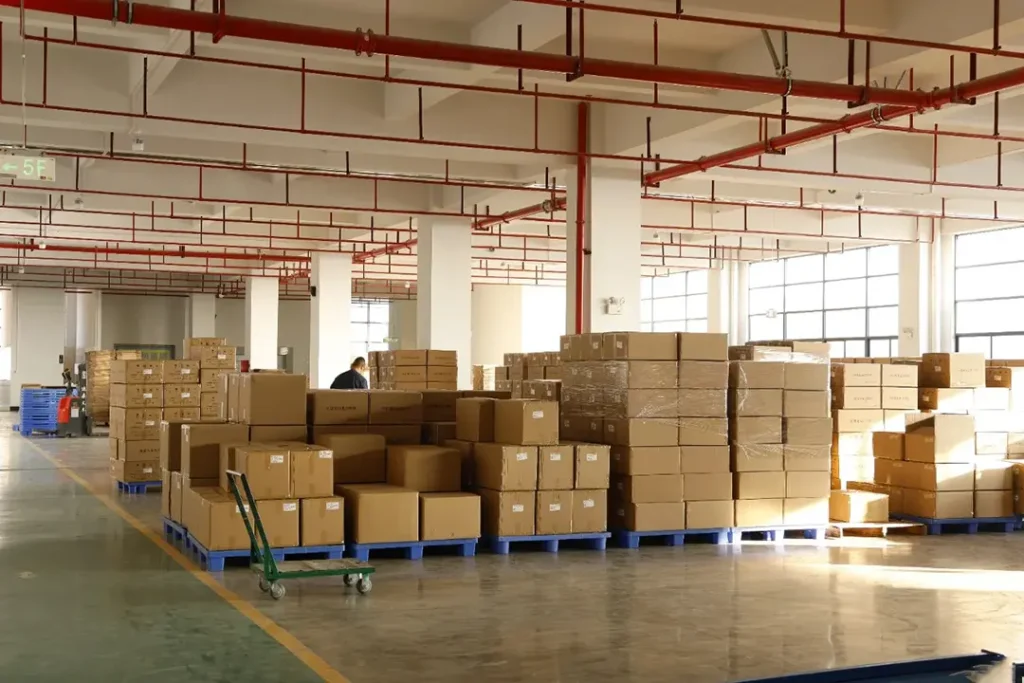 Organized warehouse storage area with pallet racks, clear aisles and proper lighting for OEM projector headlights handling