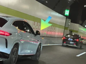 Vehicle driving in tunnel illustrating add-on blind spot lights for older cars