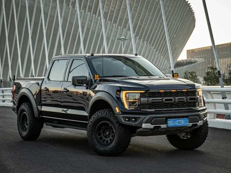 Ford Raptor melaju di jalan raya dengan lampu grill aftermarket yang dipasang di kisi-kisi depan