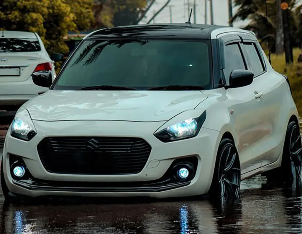 Upgraded Suzuki Swift after rain with headlights and fog lights on, illustrating how to change swift headlight.
