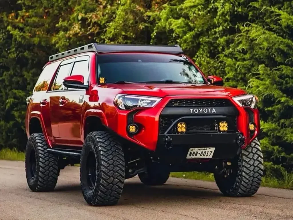 Red Toyota 4Runner with front grill lights installed, showcasing a sleek look
