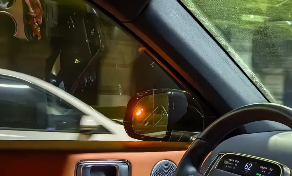 car changing lane on highway with mirror warning light showing spot lights available for safer driving
