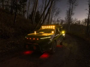 What are spotlights on a car – SUV driving at dusk with spotlights and LED light bar turned on