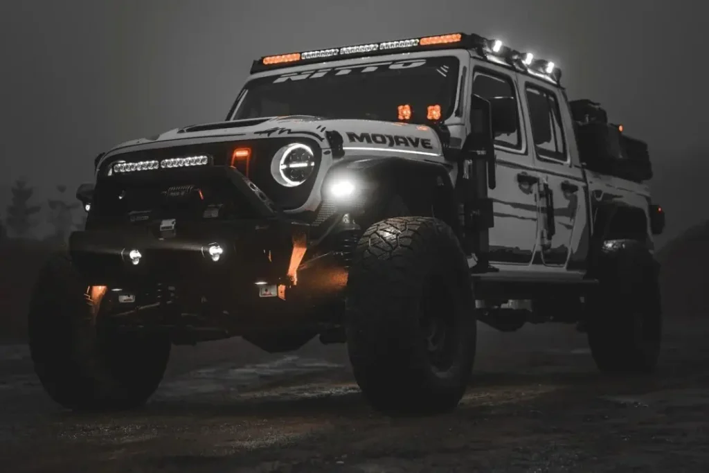 SUV with modified headlights, daytime running lights, fog lights, spotlights, and grille lights at dusk – what is the purpose of spotlights?